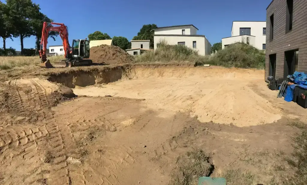 Terrassement d'un bassin avant pose d'enrochement à la pelle Kubota, aménagement en Finistère Sud